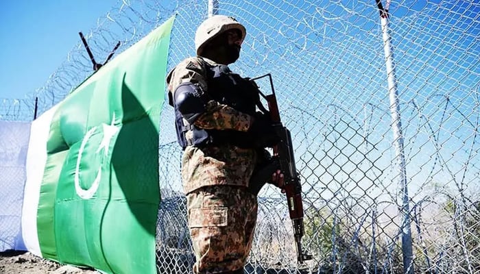 A Pakistani soldier keeps vigil next to a newly fenced border fencing along with Afghans Paktika province border in Angoor Adda in Pakistan’s South Waziristan on Oct 18, 2017. — AFP