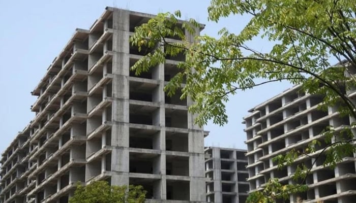 Unfinished apartment buildings stand at a residential complex developed by Jiadengbao Real Estate in Guilin, Guangxi Zhuang Autonomous Region, China. — Reuters/File