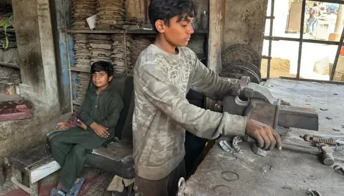 Young boys pictured while working at a metal workshop in Pakistan. — Unicef