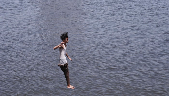 A youngster jumps into Arabian Sea water during a hot summer day in Karachi, May 2, 2026. — Online