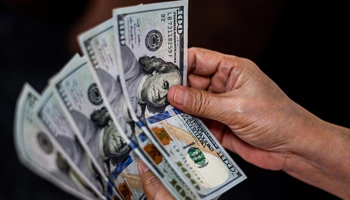 A person shows US dollars at a currency exchange store in Manila, Philippines, October 21, 2022. — Reuters