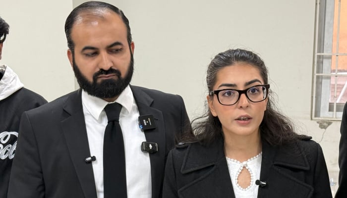Human rights lawyer Imaan Mazari (right) with her husband and fellow lawyer Hadi Ali Chattha (left), during a court hearing in Islamabad, on December 5, 2025. — AFP