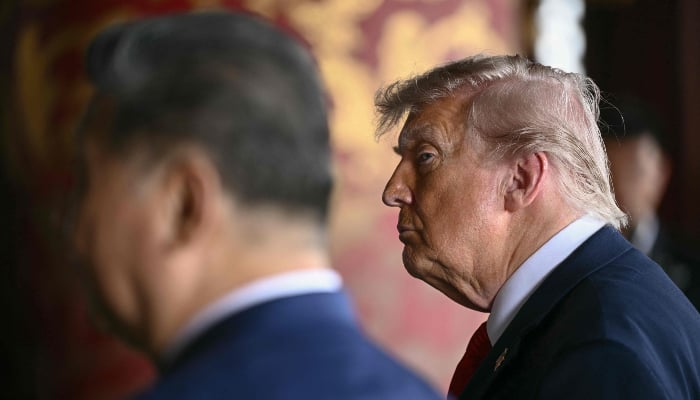 Chinas President Xi Jinping (L) and US President Donald Trump visit the Temple of Heaven in Beijing on May 14, 2026. — AFP