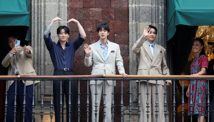 Members of South Korean Kpop boy band BTS and Mexicos President Claudia Sheinbaum react as they stand on a balcony of the National Palace ahead of a series of concerts on the BTS World Tour Arirang in Mexico City, Mexico, May 6, 2026. — Reuters