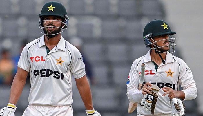 Pakistans Azan Awais (R) and Abdullah Fazal walk off the field at the end of the the first day of the second Test cricket match between Bangladesh and Pakistan at the Sylhet International Cricket Stadium in Sylhet on May 16, 2026. — AFP