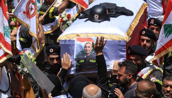Fellow rescuers carry the coffins of two members of the civil defence who were reportedly killed in Israeli airstrikes in Nabatieh the previous day, during their funeral in the southern city of Sidon, Lebanon, on May 13, 2026. — AFP