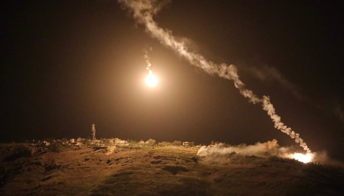 A photograph taken from the southern area of Marjayoun shows flares fired by the Israeli military descending over the village of Arnoun late on May 13, 2026. — AFP