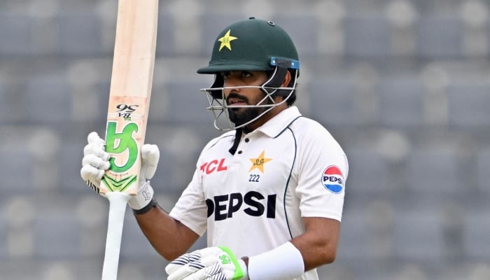 Pakistans Babar Azam celebrates after scoring a half-century during the second day of the second Test against Bangladesh at the Sylhet International Cricket Stadium, Sylhet, May 17, 2026. — AFP