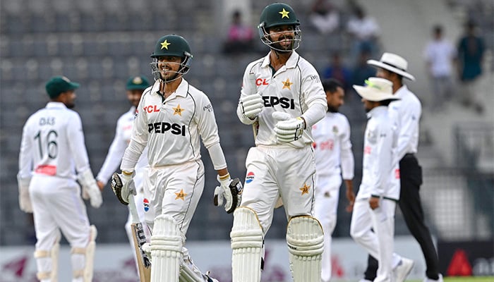 Pakistans Azan Awais (L) and Abdullah Fazal walk off the field at the end of third day of the second Test cricket match between Bangladesh and Pakistan at the Sylhet International Cricket Stadium in Sylhet on May 18, 2026. — AFP