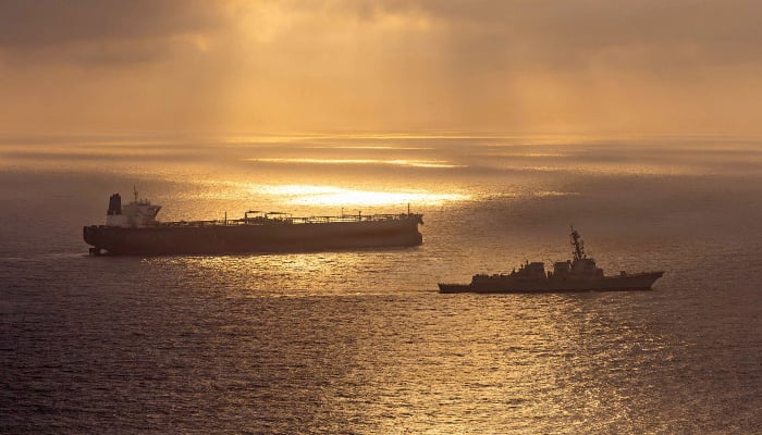 This US Navy handout photo released on May 8, 2026, by US Central Command Public Affairs, shows the Arleigh Burke-class guided-missile destroyer USS Rafael Peralta (DDG 115) implementing a maritime blockade against the Iran-flagged crude oil tanker vessel Herby while the latter was attempting to sail toward an Iranian port, on April 24, 2026. — AFP
