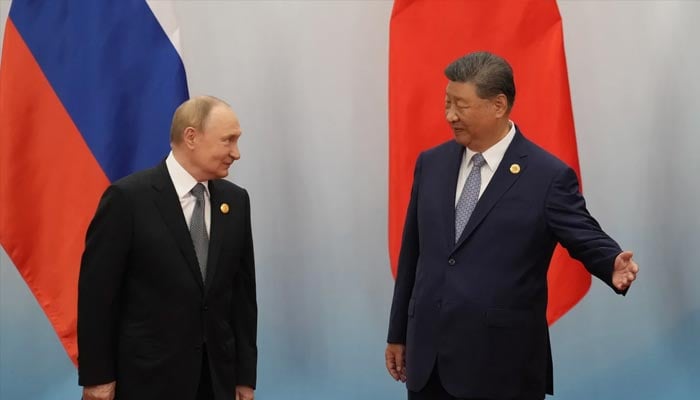 Chinese President Xi Jinping shows the way to Russian President Vladimir Putin after the photo session of the Shanghai Cooperation Organization (SCO) Summit 2025 in Tianjin on September 1, 2025. — AFP