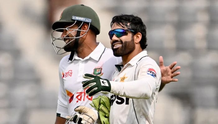 Bangladeshs Litton Das (L) and Pakistans Mohammad Rizwan walk back to the pavilion for tea break during the first day of the second Test cricket match between Bangladesh and Pakistan at the Sylhet International Cricket Stadium in Sylhet on May 16, 2026. — AFP