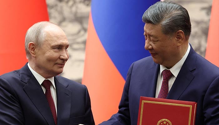 Russian President Vladimir Putin and Chinese President Xi Jinping shake hands during a signing ceremony at the Great Hall of the People in Beijing, China, May 20, 2026. — Reuters