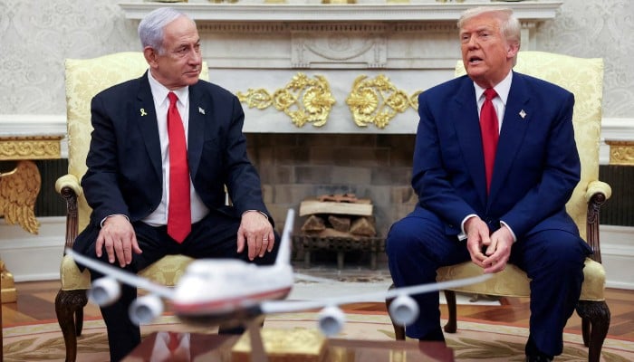 US President Donald Trump talks to Israeli Prime Minister Benjamin Netanyahu during a meeting where Trump announced nuclear talks with Iran, Washington, US, April 7, 2025. — Reuters