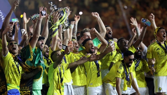 Al Nassr´s players celebrate with the trophy after winning the Saudi Pro League title at the end of their football match against Damac at the Al-Awwal Park Stadium in Riyadh on May 21, 2026. — AFP