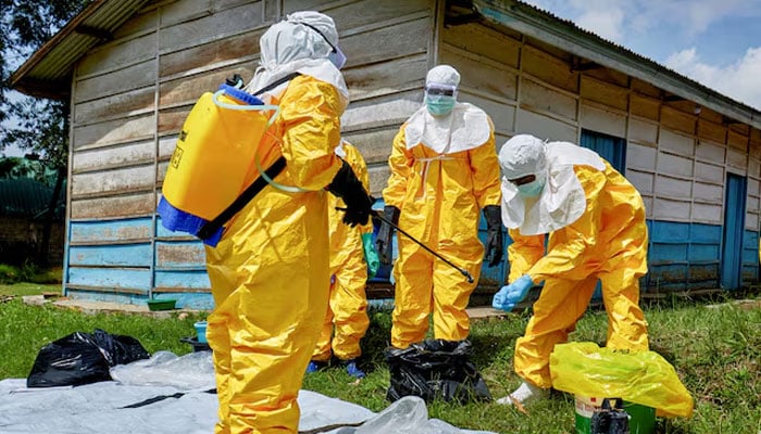 Red Cross workers disinfect after handling the body of a person who died of Ebola, as aid agencies intensify efforts to contain a new Ebola outbreak involving the Bundibugyo strain, at the Centre Medical Evangelique (CME) in Hoho commune of Bunia, Ituri province, Democratic Republic of Congo, May 21, 2026. — Reuters