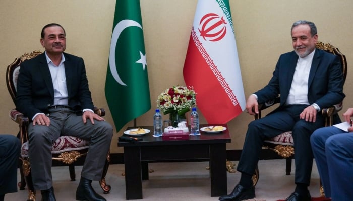 Chief of Army Staff and Chief of Defence Forces Field Marshal Syed Asim Munir (left) and Iranian Foreign Minister Abbas Araghchi hold a meeting in Tehran on May 22, 2026. — X@Iran_GOV