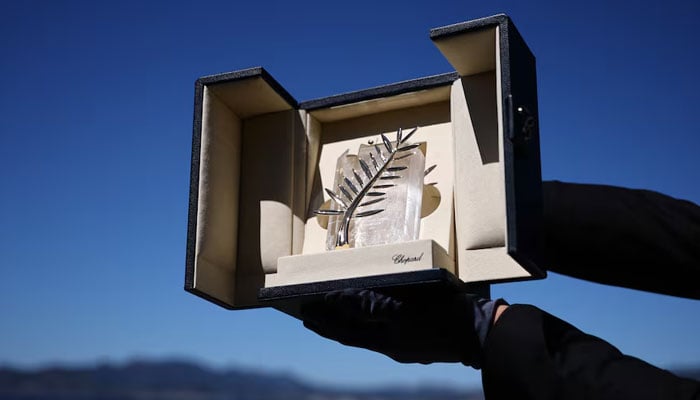 A Chopard representative displays the Palme dOr, the highest prize awarded to competing films, during an interview before the start of the 79th Cannes Film Festival in Cannes, France, May 12, 2026. — Reuters