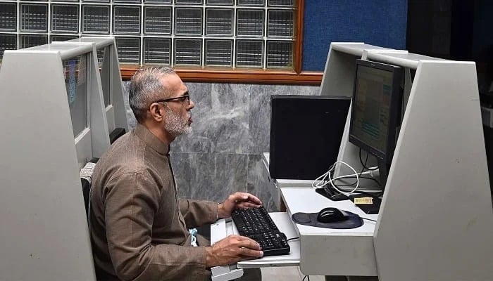 A stockbroker monitors share prices during a trading session at the PSX in Karachi, January 21, 2025. — INP