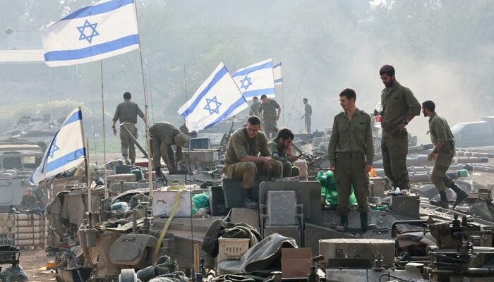 Israeli soldiers stand on tanks, amid the ongoing conflict between Israel and the Palestinian group Hamas, near the Israel-Gaza border, in southern Israel, January 1, 2024.— Reuters