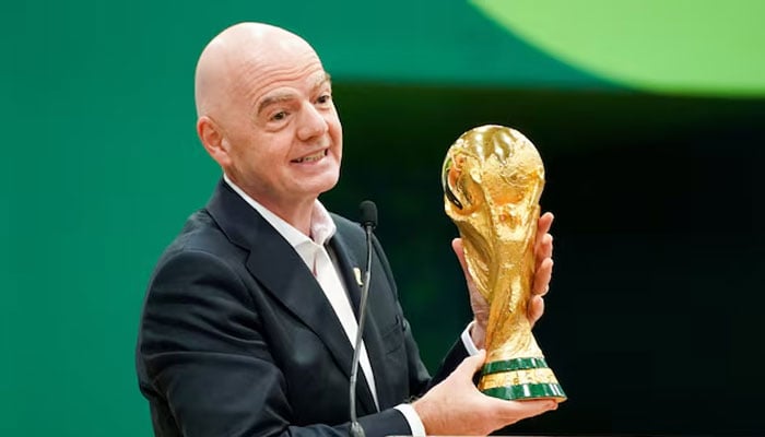 Fifa President Gianni Infantino holds the World Cup trophy while he speaks during the grand opening of the 2026 FIFA World Cup international broadcast centre at Kay Bailey Hutchison Convention Centre. — Reuters