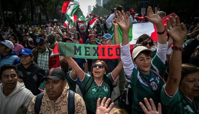Thousands of Mexicans packed the capital citys streets in an effort to set a new Guinness record for the worlds largest human wave. — AFP