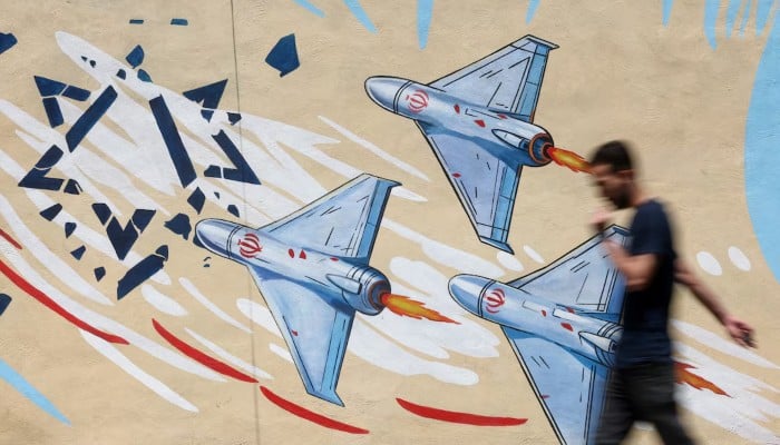 An Iranian man walks next to an anti-Israeli mural on a street in Tehran, Iran June 6, 2026. — Reuters