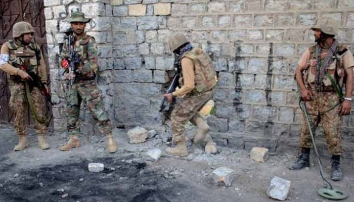 In this file photo, security forces are seen taking position during an operation. — ISPR/File
