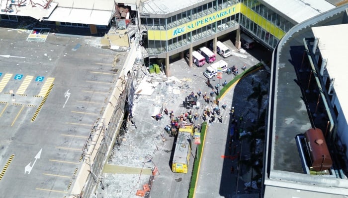 A drone view shows emergency personnel and people standing near damaged buildings after a magnitude 7.8 quake in General Santos, Mindanao Island, Philippines, June 8, 2026. — Reuters