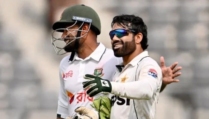 Bangladeshs Litton Das (L) and Pakistans Mohammad Rizwan walk back to the pavilion for tea break during the first day of the second Test cricket match between Bangladesh and Pakistan at the Sylhet International Cricket Stadium in Sylhet on May 16, 2026. — AFP