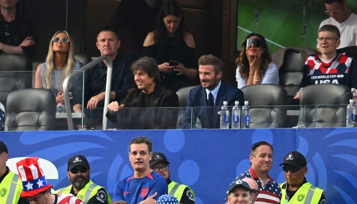 US actor Tom Cruise (C-L) and English former footballer David Beckham (C-R) attend the 2026 World Cup Group D football match between USA and Paraguay at the Los Angeles Stadium in Inglewood on June 12, 2026. — AFP