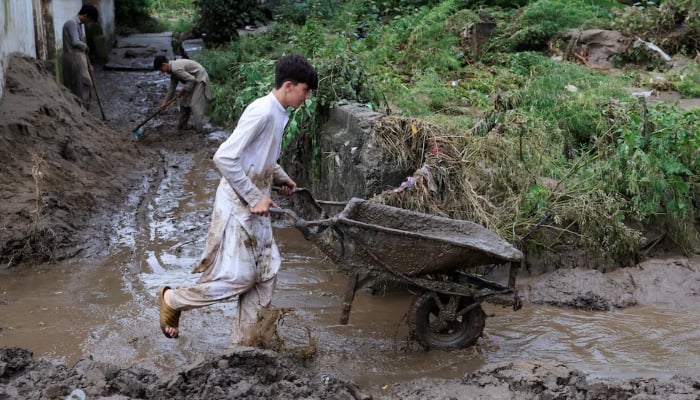 Residents clear a street following a storm that caused heavy rains and flooding in Bayshonai Kalay, in Buner district, in Khyber Pakhtunkhwa province, August 17, 2025. — Reuters