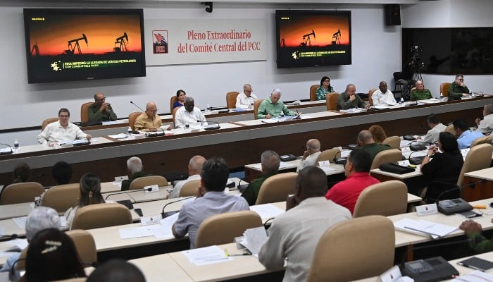 This handout picture released by the Cuban Presidency shows Cubas President Miguel Diaz Canel (C, in green) attending a Communist Party meeting in Havana on June 17, 2026. — AFP