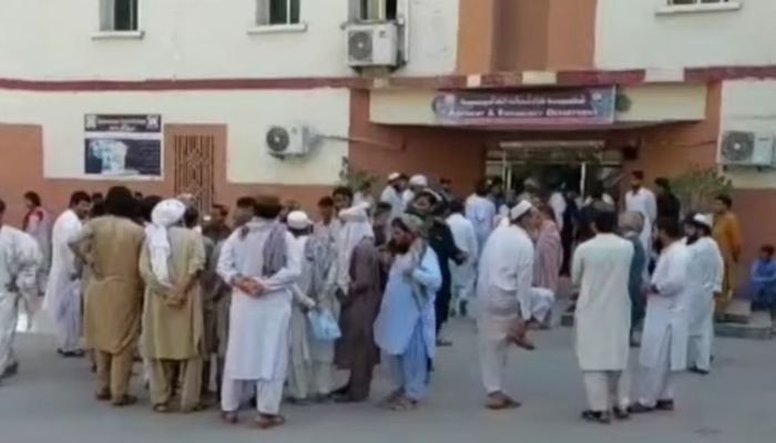 People gather outside a hospital after twin blasts in Bannu on June 20, 2026. — Geo News
