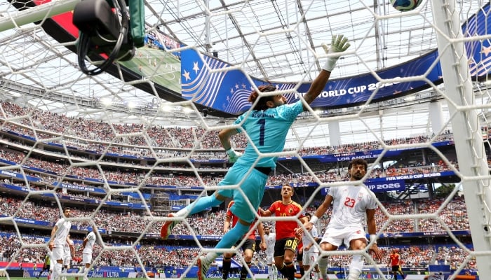 Belgiums Leandro Trossard and Irans Alireza Beiranvand and Ramin Rezaeian watch a shot from Belgiums Dodi Lukebakio go wide on June 21, 2026. — Reuters