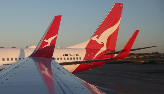 A Qantas logo is visible on the tail of an aeroplane at an airport in Sydney, Australia, September 18, 2025. — Reuters