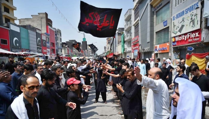 A large number of mourners beating themselves during a procession at Sadar Road on 9th of the Holy Month of Muharramul Haram in Peshawar on June 25, 2026. — APP