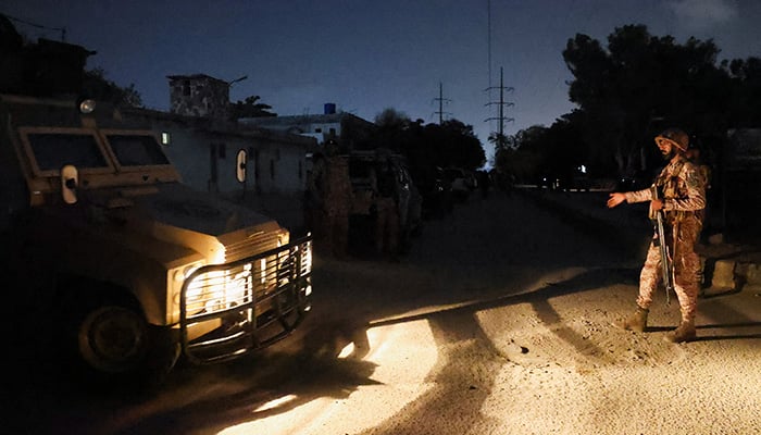 A paramilitary soldier gives way to a personal armoured carrier after an explosion and gunfire were reported near the offices of the Rangers, a paramilitary force, in Karachi, June 27, 2026. — Reuters