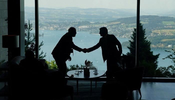 Delegation staff members meet in the lobby on the day of a quadrilateral meeting between the Pakistan, United States, Iran, and Qatar at the Burgenstock luxury hotel complex overlooking Lake Lucerne, Switzerland, on June 21, 2026. — AFP