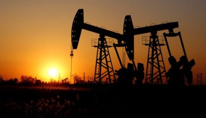 Pumpjacks are seen against the setting sun at the Daqing oil field in Heilongjiang province, China December 7, 2018.  — Reuters