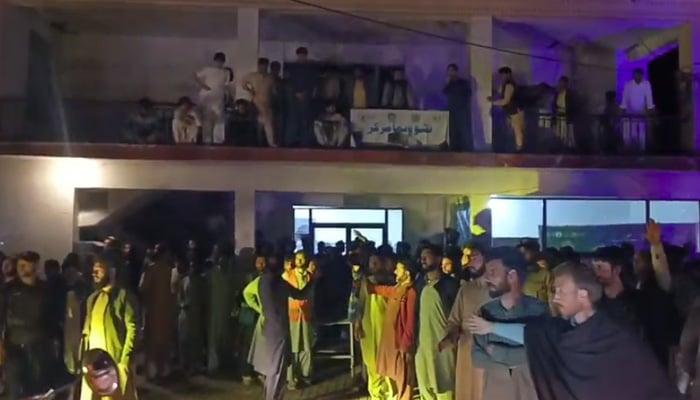 People gather outside Kalam Hospital after rescue teams bring victims of tourist boat accident at Saifullah Lake, Swat, on July 1, 2026. — Screengrab via Geo News