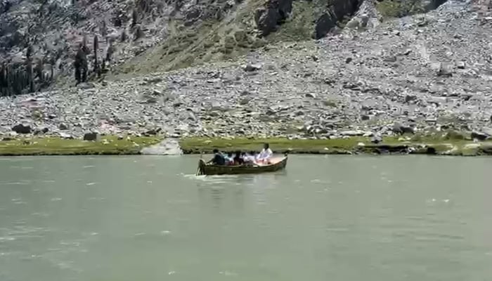 Tourists ride a boat at Saifullah Lake, a popular tourist attraction on the Swat River in Swat. — Geo News/File
