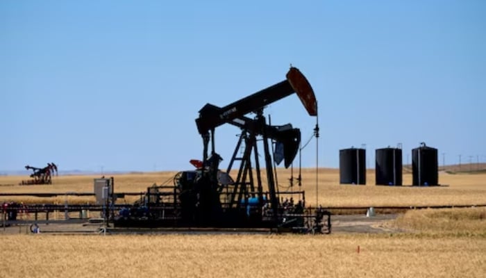 Oil pumpjacks and tanks are pictured in a farmer’s field near Kindersley, Saskatchewan, Canada September 5, 2024. — Reuters