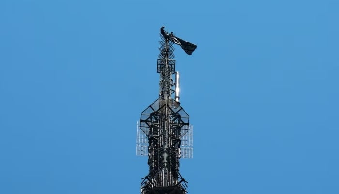 Two people display a banner as they stage a protest atop the Empire State Building in the Manhattan borough of New York, US, July 1, 2026. — Reuters