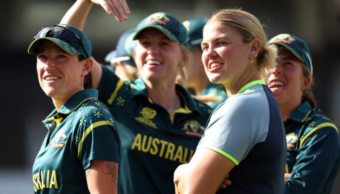 Australias Megan Schutt and teammates celebrate after the match. — Reuters