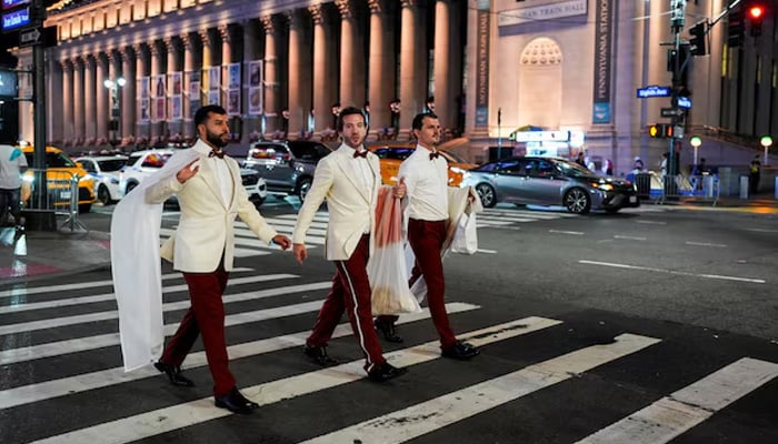 Workers believed to be a part of the reported wedding between singer Taylor Swift and National Football League (NFL) player Travis Kelce, cross a road outside Madison Square Garden, in New York City, US, July 3, 2026. — Reuters