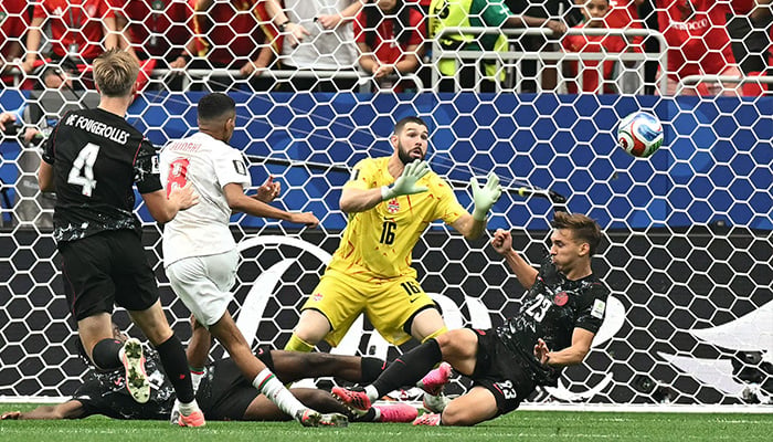 Moroccos midfielder #08 Azzedine Ounahi scores his teams second goal past Canadas goalkeeper #16 Maxime Crepeau during the 2026 World Cup round of 16 football match between Canada and Morocco at the Houston Stadium in Houston on July 4, 2026. — AFP